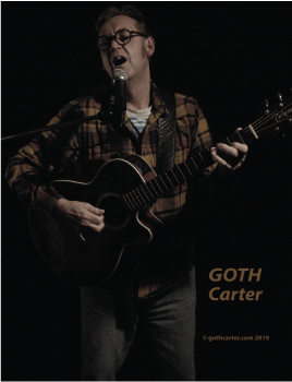 GOTH Carter studio photo with acoustic guitar standing up.